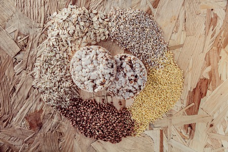 Collection Set of Cereal Grains: Millet, Corn, Rice, Buckwheat, closeup, shot on a wooden surface Oat , breadの写真素材