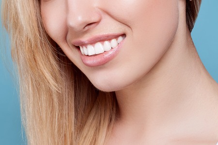 Beautiful woman smiling. portrait of attractive caucasian smiling woman blond on blue studio shot, studio shotの写真素材