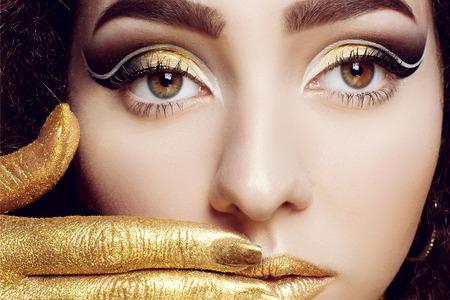 Magic Girl Portrait in Gold. Golden Makeup, close-up portrait in studio shot, colorの写真素材