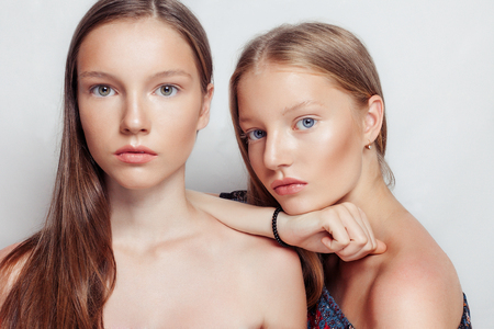 studio portrait of two young beautiful women. Beauty Woman face Portrait. Beautiful Spa model Girl with Perfect Fresh Clean Skin. Youth and Skin Care Concept.の写真素材