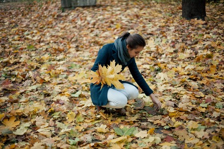 autumn walk girl in the coat in the woods