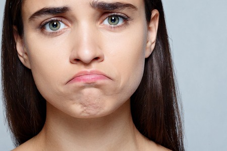 people, luxury and fashion, emotions concept - Portrait of young woman with shocked expression of sadnessの写真素材