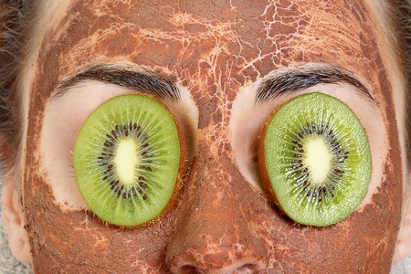 spring, health, people, youth and beauty concept -Natural homemade fruit facial masks. Fresh fruit. Spa Woman applying Facial cleansing Mask. Beauty Treatmentsの写真素材