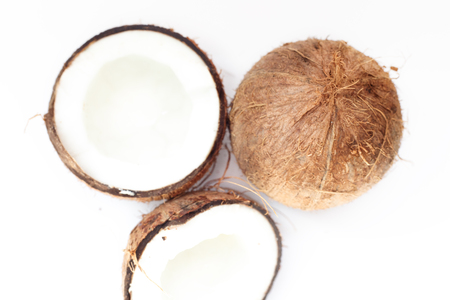 Food, minimalism, color, still life and natural concept - Ripe coconuts and half coconut on white backgroundの写真素材