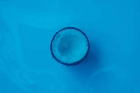 Food, minimalism, color, still life and natural concept - half Coconut isolated on blue Background. Clipping Pathの写真素材