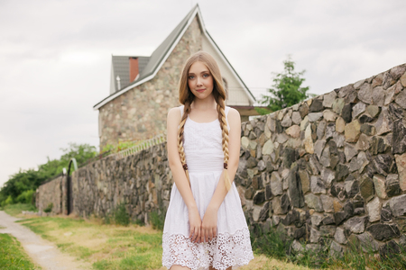 nature, architecture, people, fashion, natural concept -Fashion portrait of beautiful boho style girl near scandinavian house, house made of granite, straw. Girl in the country.の写真素材