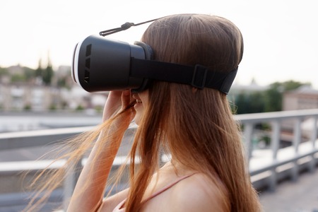 business,technologies, VR, people and lifestyle concept - amazed young beautiful girl using new VR...