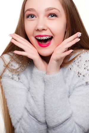 teeth,emotions, health, people, dentist and lifestyle concept - Healthy, beautiful smile, the child to the dentist.Portrait of a little girl with orthodontic appliance .の写真素材