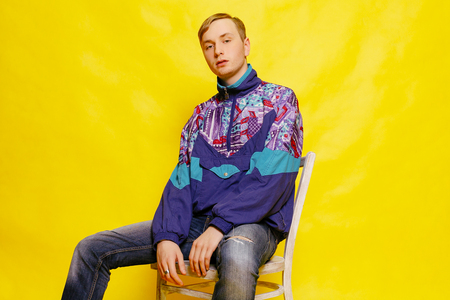 emotions, people and lifestyle concept - Male teenager on a bright background, redhead male....