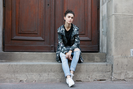 People, beauty, fashion, lifestyle and color concept - Outdoor full body portrait of young beautiful happy smiling girl posing on street. Model looking at camera. Lady wearing stylish clothesの写真素材