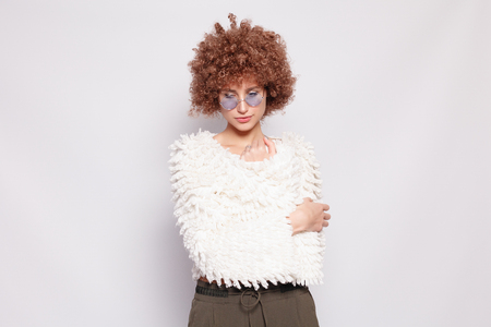 Portrait of smiling young black woman. Portrait of a beautiful young woman with African American afro haircut and glamor makeup. Studio shot. Attractive girl wearing eyeglasses.の写真素材