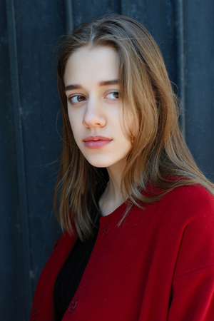 stylish beautiful woman walking in street in red coat, autumn fashion trend. Fashion autumn photo. Female fashion. City lifestyle.の写真素材