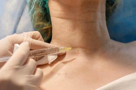 Doctor beautician makes injections in the forehead for the beauty of the patient. Beauty injections...