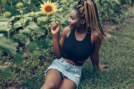 Outdoor portrait of beautiful happy mixed race African American girl teenager female young woman in...