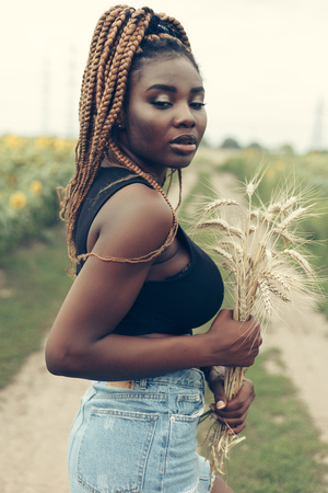 Outdoor portrait of beautiful happy mixed race African American girl teenager female young woman in...