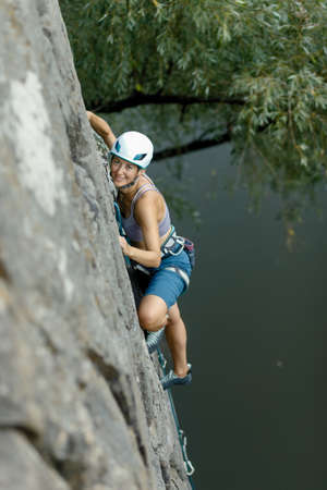fitness, extreme sport and healthy lifestyle concept - Climber overcomes challenging climbing route....