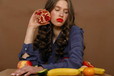 Young woman in group of fruit. Healthcare and healthy nutrition concept.の写真素材