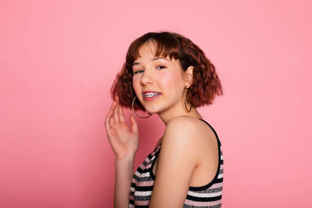 Image of young happy beautiful woman posing isolated over pink wall background.の写真素材