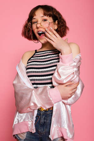 Image of young happy beautiful woman posing isolated over pink wall background.