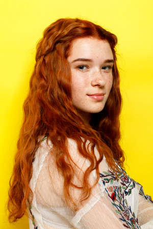 Indoor portrait of excited curly woman with trendy makeup. Ginger caucasian young lady smiling on...