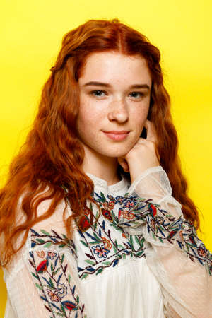 Indoor portrait of excited curly woman with trendy makeup. Ginger caucasian young lady smiling on...