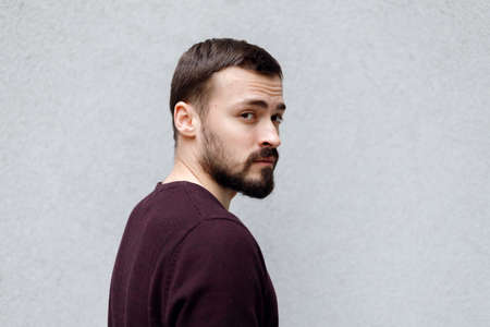 Close up portrait of smiling handsome man in white t-shirt looking at camera, isolated on gray backgroundの写真素材