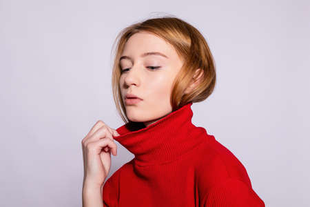 Trendy beautiful hipster girl. Photo of positive young nice woman in yellow knee-high with white background. pulls golfersの写真素材