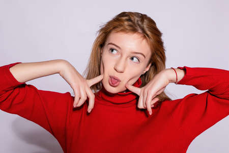 Trendy beautiful hipster girl. Photo of positive young nice woman in yellow knee-high with white background. fooling around having funの写真素材