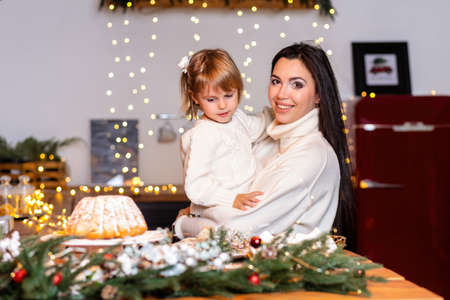 Merry Christmas and Happy Holidays. Family preparation holiday food. Mother and daughter cooking Christmas cookies.の写真素材