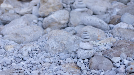 Stack balancing pebble stones pool with out of focus for backgroundの写真素材