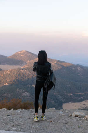 tourist woman taking a mobile shot of mountains by smart phone. Nature mobile photography concept.