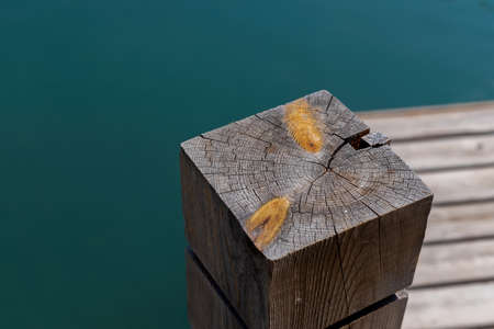Single wooden bollard with rope