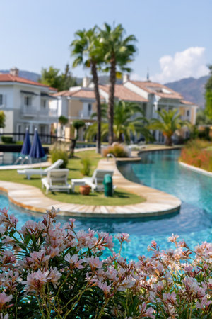 Entrance of a luxury house with beautiful landscaping on an artificial river on a brightの写真素材