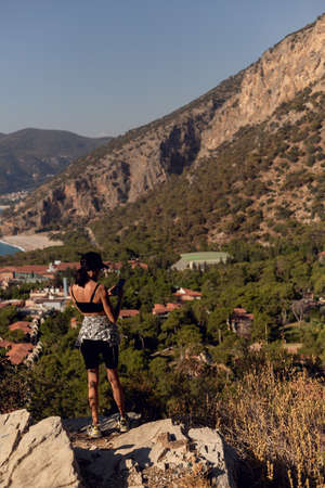 tourist woman taking a mobile shot of mountains by smart phone.の写真素材