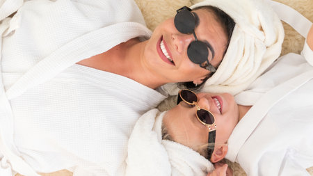 Mother with child doing beauty treatment together.