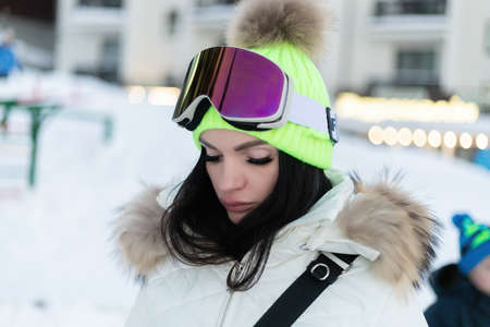 winter, leisure, sport and people concept - Happy girl snowboarder posing in sunglasses with snowboardの写真素材