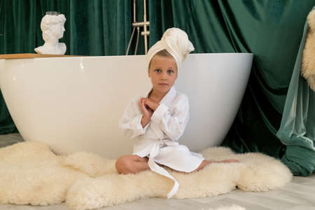 child doing beauty treatment together. child daughter in towel and bathrobe in the bathroom. beauty salon concept, wellness spa, long banner format, top view.の写真素材