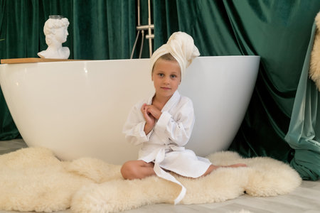 child doing beauty treatment together. child daughter in towel and bathrobe in the bathroom. beauty salon concept, wellness spa, long banner format, top view.の写真素材