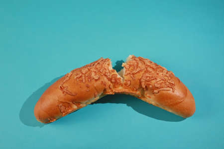 broken bun with cheese on a blue background. Design, Fine Art, Minimalismの写真素材