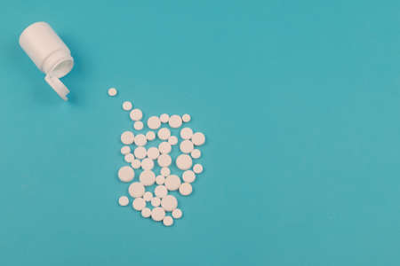 White tablets and bottle for tablets on blue background. Design, Fine Art, Minimalismの写真素材