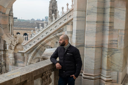 Travel, holidays and winter vacations concept - Happy man take selfie photo with funny pigeons in front of Duomo Milan Cathedralの写真素材
