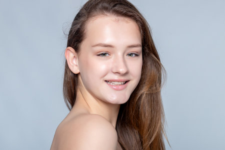 Captivating simplicity portrayed by a young woman embracing her flawless complexion. Perfect for skincare brands and beauty influencers.の写真素材
