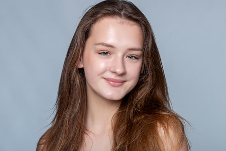 Radiate confidence with an image of a young woman showing her flawless skin. Ideal for beauty product advertisements.の写真素材