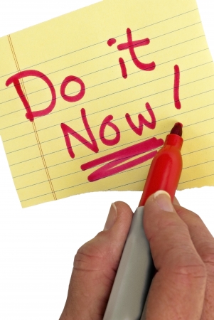 Hand writing Do It Now with a red marker   Don t procrastinate   It s important to get your jobs done and not put it off   Studio shot の写真素材
