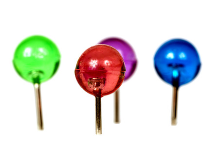 Group Of Brightly Colored Pushpins Isolated On White