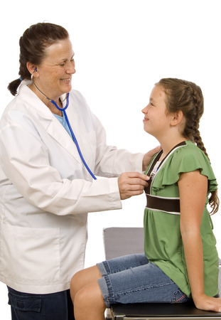 Friendly Doctor Examines Smiling Little Girlの写真素材