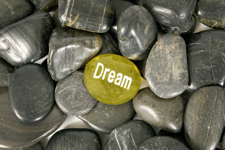 Dream Encouragement River Stone Surrounded By Other Stonesの写真素材