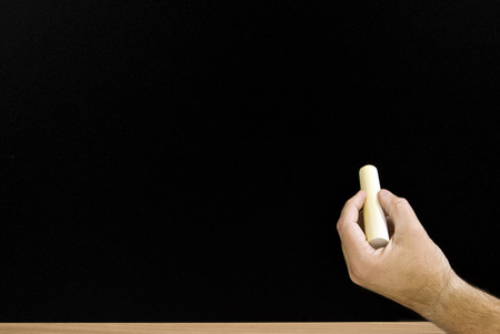Hand With Chalk and Blackboardの写真素材