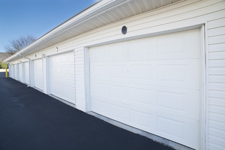 Row of garage doors at parking area for apartment homesの写真素材