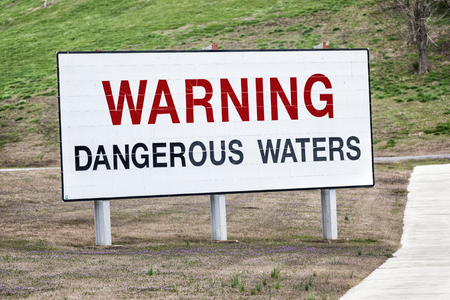 A big sign near a hydroelectric dam in Tennessee warns boaters, swimmers and others of the dangerous waters below.の写真素材